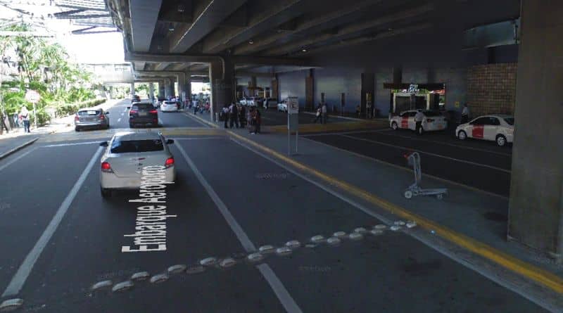 veículos e passageiros em frente ao portão de desembarque no aeroporto do Recife